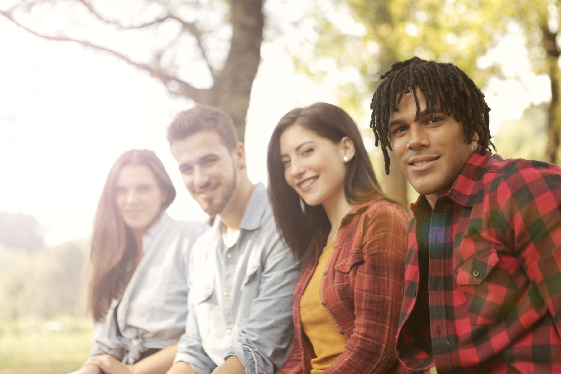 Friends laughing on a bench