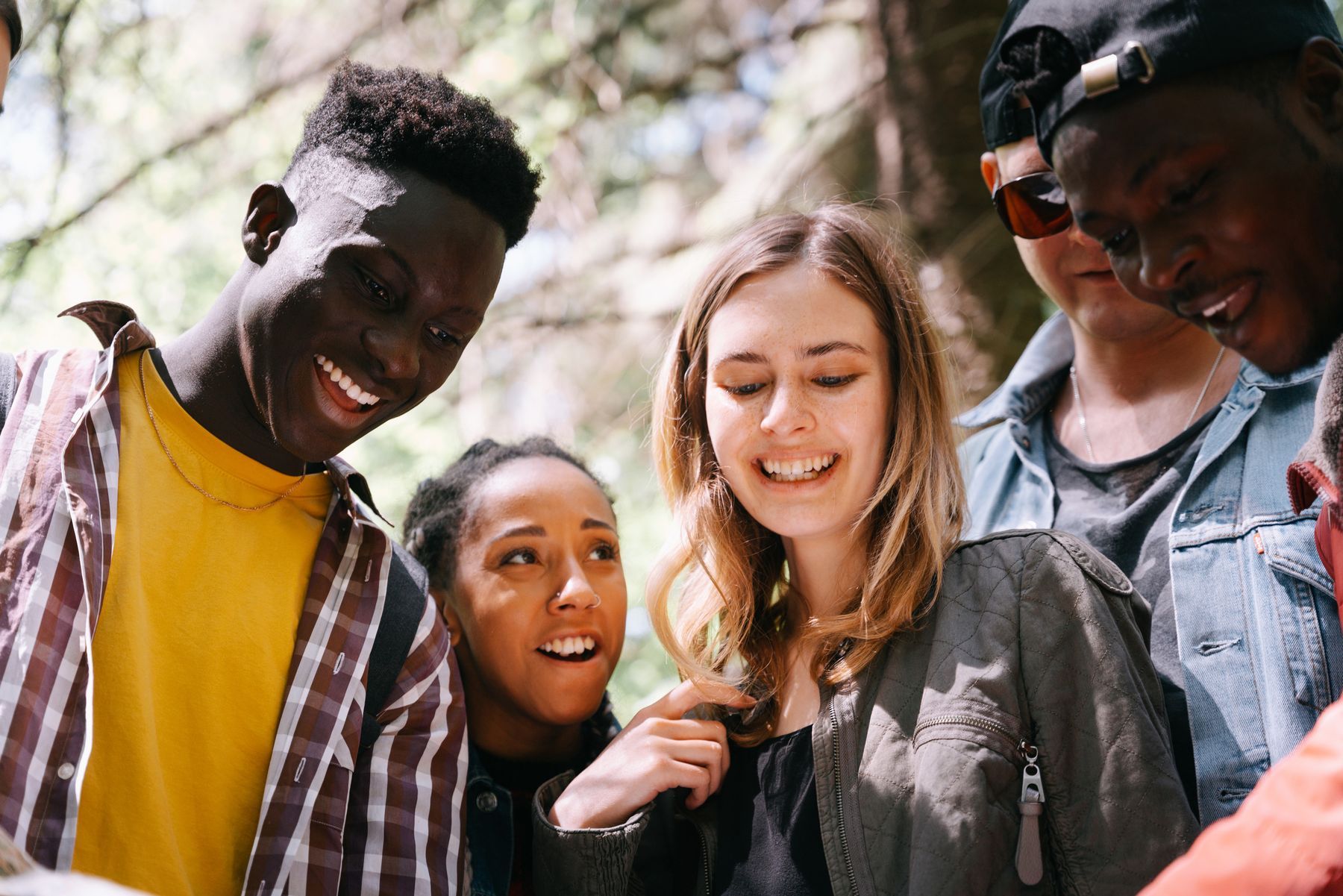 Young adults laughing together outdoors